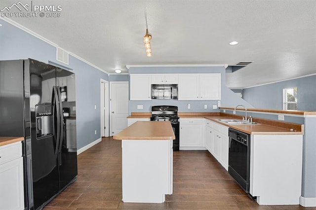 kitchen with a sink, black appliances, ornamental molding, visible vents, and a kitchen island