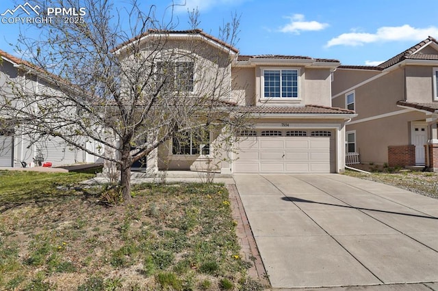 traditional-style house with a garage, a tiled roof, driveway, and stucco siding