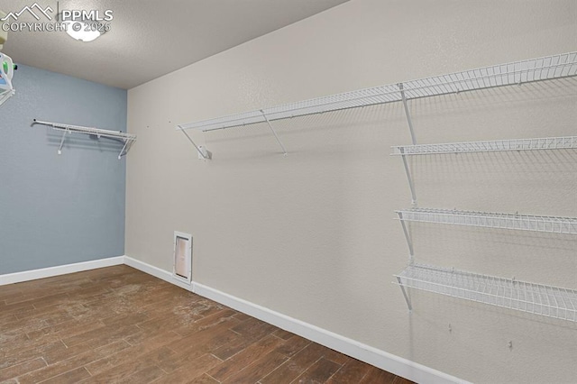 spacious closet with wood finished floors
