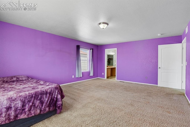 carpeted bedroom featuring baseboards and a textured ceiling