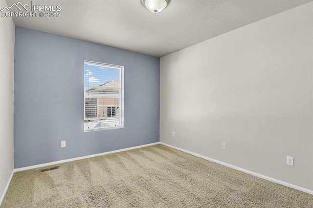 unfurnished room with baseboards and carpet