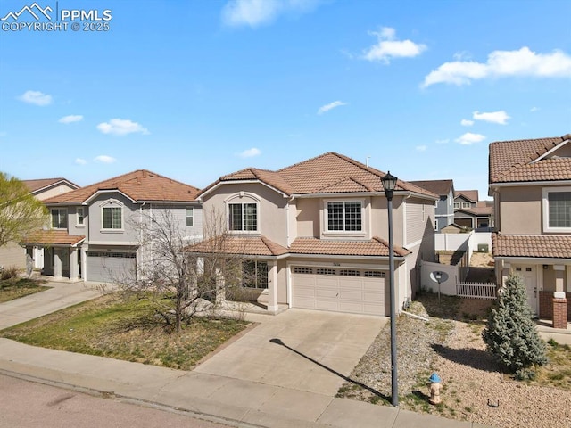 view of front facade featuring a garage, driveway, a tiled roof, and stucco siding