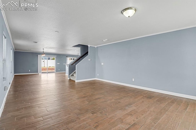 unfurnished living room with baseboards, ornamental molding, stairs, and dark wood-style floors