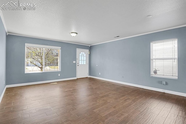 unfurnished living room featuring baseboards, dark wood-type flooring, and ornamental molding