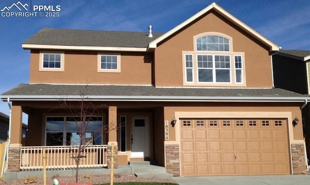 10394 Abrams Dr, Colorado Springs, CO 80925 - view of front of house with roof with shingles, stucco siding, stone siding, an attached garage, and covered porch