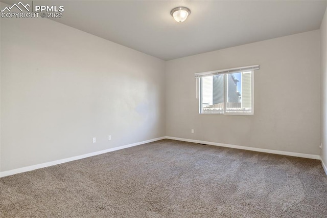 empty room with carpet flooring and baseboards