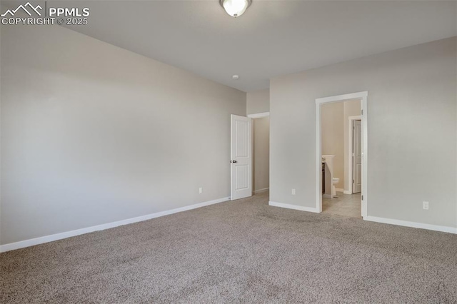 unfurnished bedroom featuring baseboards, connected bathroom, and light colored carpet
