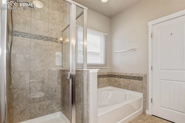 full bathroom with a shower stall, tile patterned flooring, and a garden tub