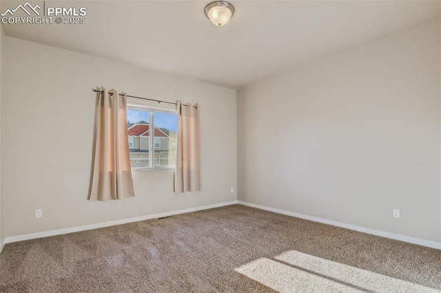 empty room with carpet flooring and baseboards