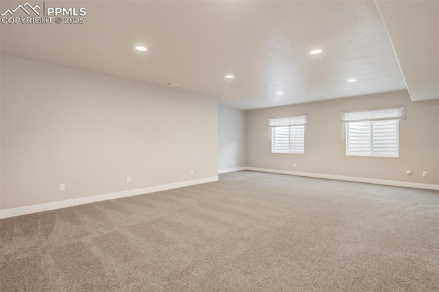 carpeted spare room featuring recessed lighting and baseboards