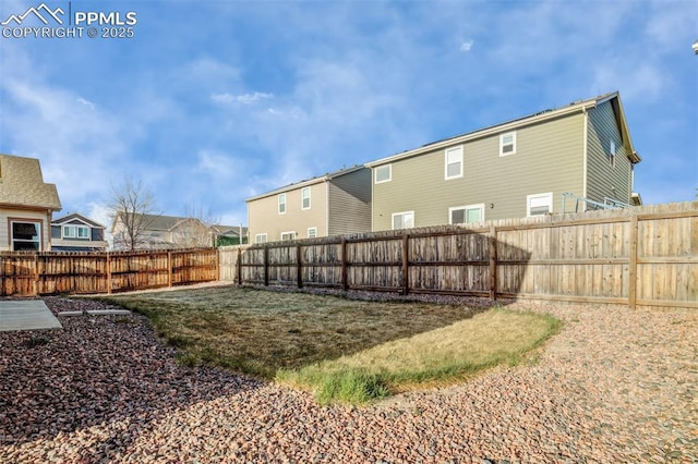 back of property with a residential view and a fenced backyard