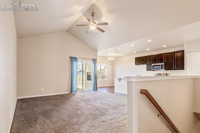 unfurnished living room with recessed lighting, carpet, ceiling fan with notable chandelier, and baseboards