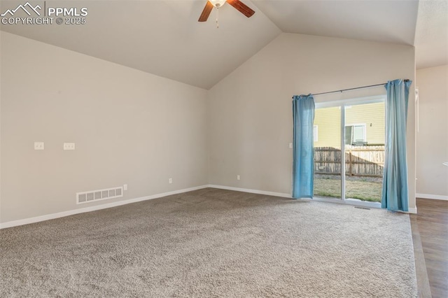 spare room featuring a ceiling fan, visible vents, carpet floors, lofted ceiling, and baseboards