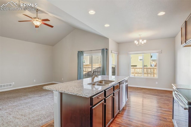 kitchen featuring visible vents, baseboards, a sink, appliances with stainless steel finishes, and ceiling fan with notable chandelier