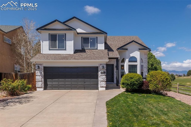 traditional-style house featuring fence, brick siding, a garage, a front yard, and concrete driveway