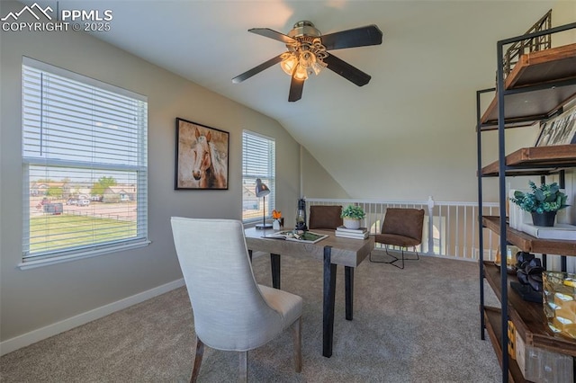 carpeted home office with a ceiling fan, baseboards, and lofted ceiling