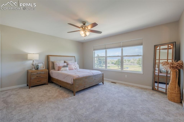 carpeted bedroom with baseboards, a ceiling fan, and visible vents