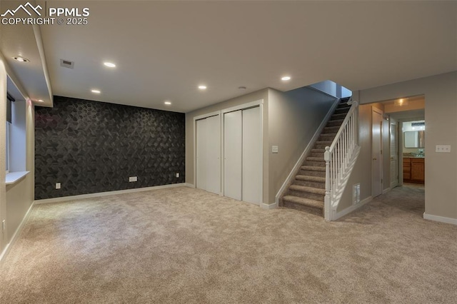 below grade area with stairway, baseboards, and carpet