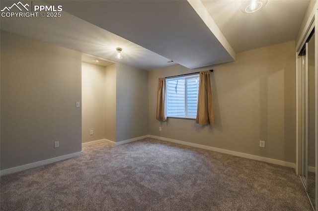 carpeted empty room with baseboards