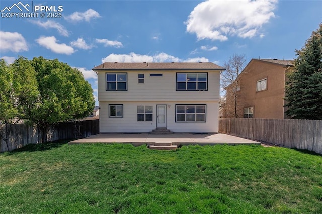 rear view of house featuring a lawn, entry steps, a fenced backyard, and a patio area