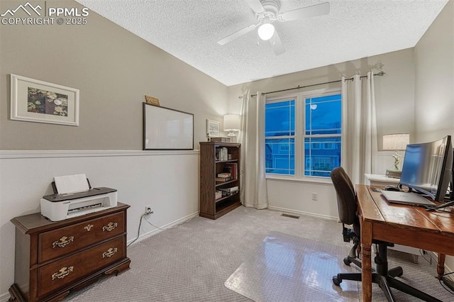 home office featuring carpet floors, visible vents, baseboards, a textured ceiling, and a ceiling fan