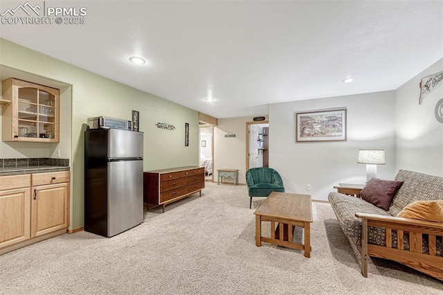 living area with recessed lighting and light carpet