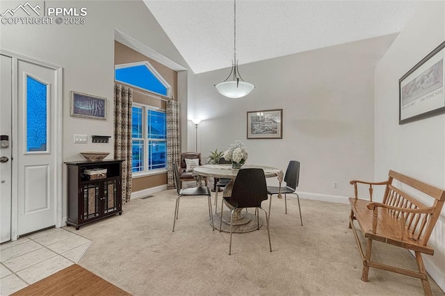dining area featuring high vaulted ceiling, baseboards, light carpet, and visible vents