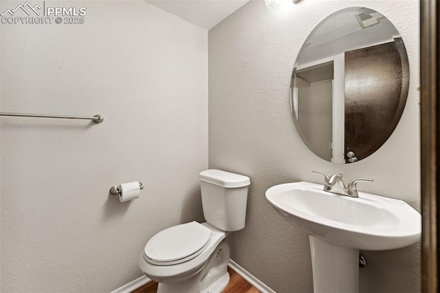 365 Waco Ct, Colorado Springs, CO 80919 - bathroom with toilet, baseboards, and wood finished floors