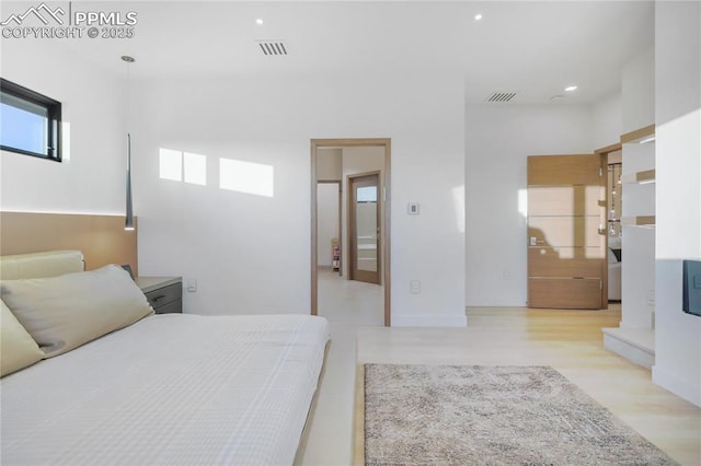 bedroom with wood finished floors, visible vents, and recessed lighting
