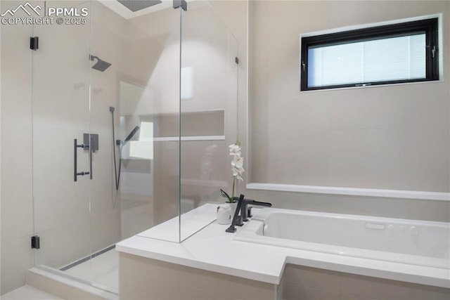full bath with a bath and a shower stall