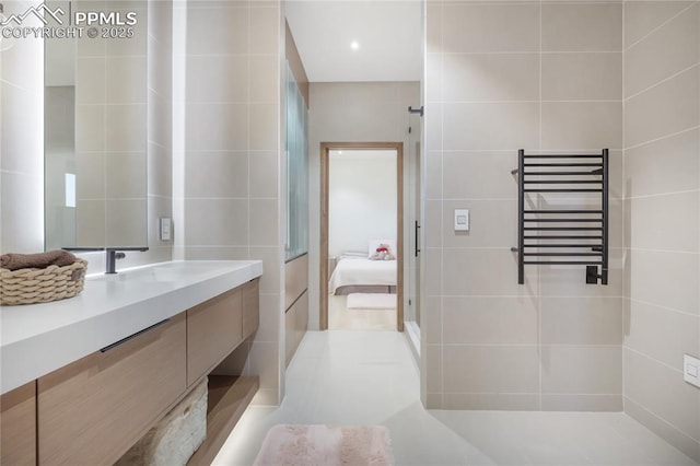 bathroom featuring ensuite bath, radiator heating unit, vanity, and tile walls