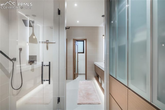 full bathroom featuring tile walls and a stall shower