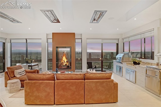 living room featuring light tile patterned flooring and recessed lighting