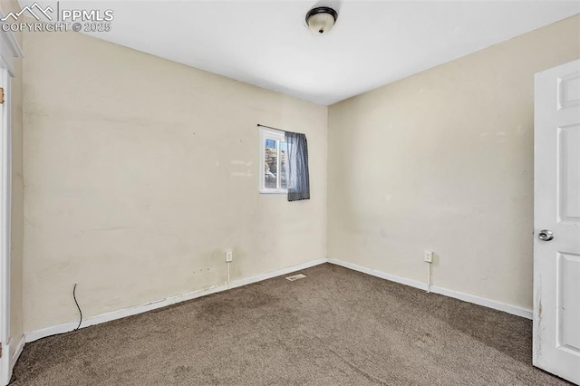 carpeted spare room with baseboards