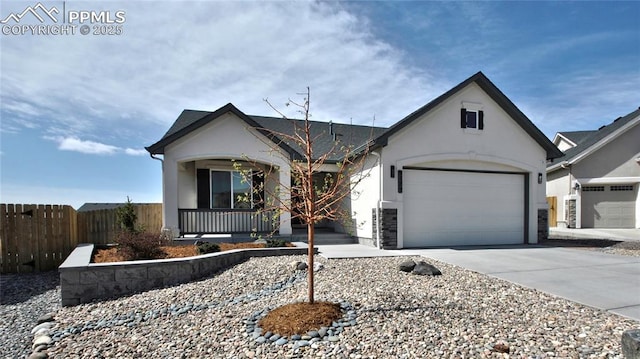 view of front of property featuring concrete driveway, stucco siding, a garage, fence, and covered porch