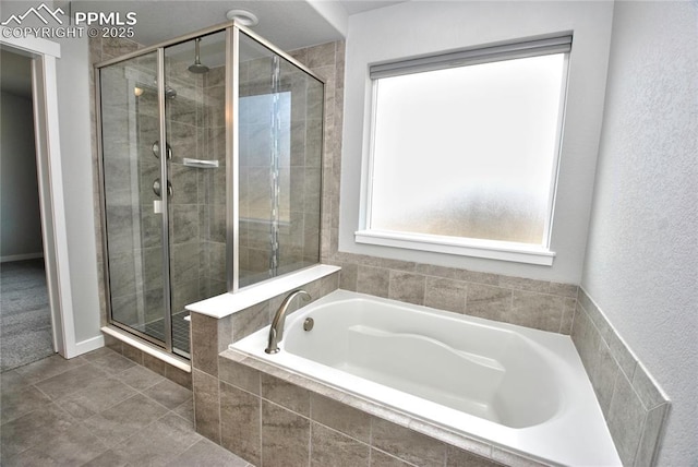 bathroom with a bath and a shower stall