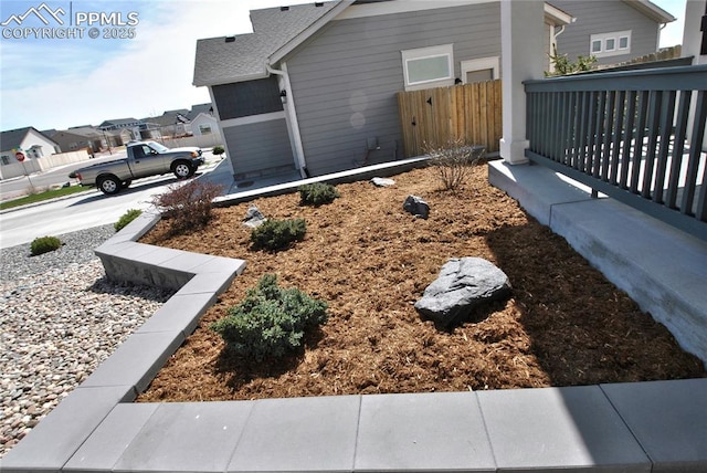 view of yard featuring fence and a residential view