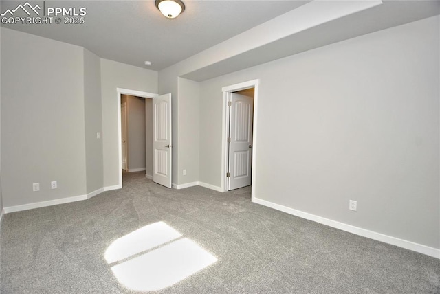unfurnished bedroom with carpet floors and baseboards