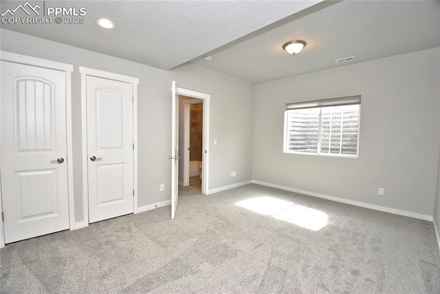 unfurnished bedroom featuring carpet flooring, baseboards, visible vents, and recessed lighting