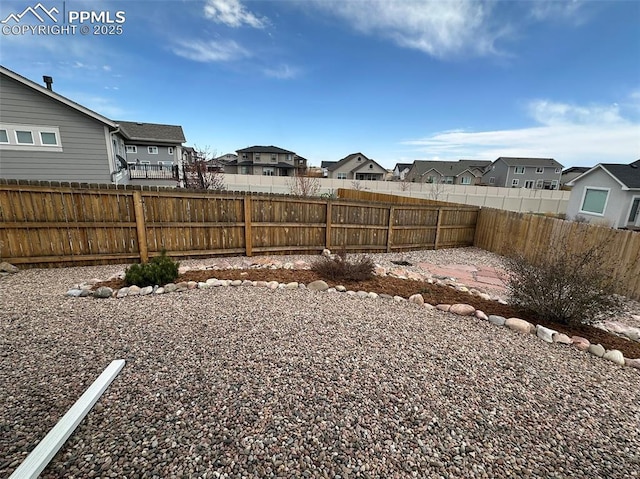view of yard featuring a residential view and a fenced backyard