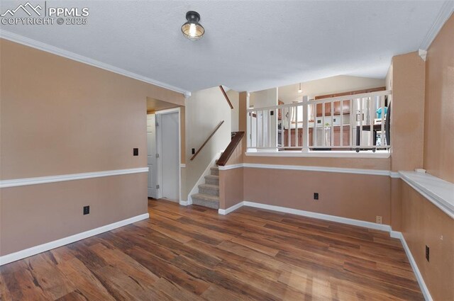 3828 Breaking Dawn St, Colorado Springs, CO 80925 - unfurnished room with stairs, baseboards, ornamental molding, and wood finished floors