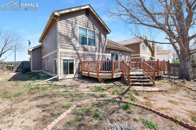 3828 Breaking Dawn St, Colorado Springs, CO 80925 - rear view of property with a wooden deck and a fenced backyard