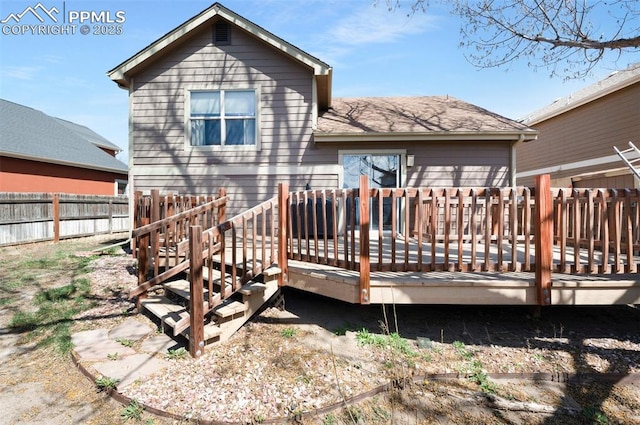 3828 Breaking Dawn St, Colorado Springs, CO 80925 - back of property with fence, a wooden deck, and roof with shingles