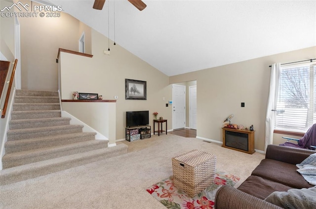 3828 Breaking Dawn St, Colorado Springs, CO 80925 - living room with baseboards, carpet flooring, stairway, a ceiling fan, and high vaulted ceiling