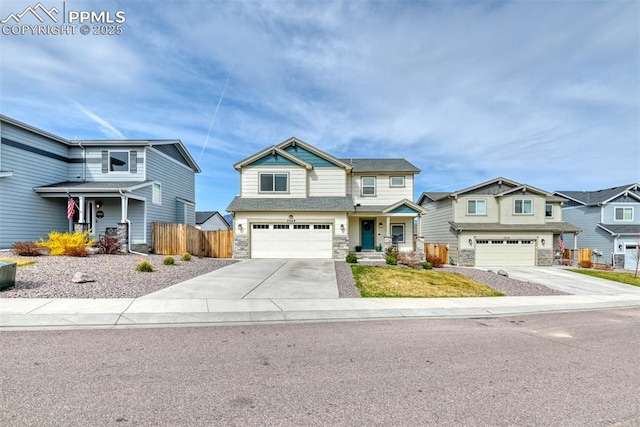 view of front of home with a garage, fence, stone siding, driveway, and a residential view