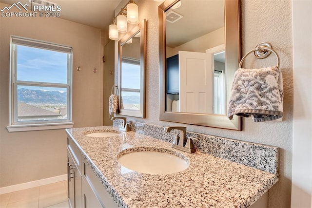 full bathroom with double vanity, visible vents, baseboards, and a sink