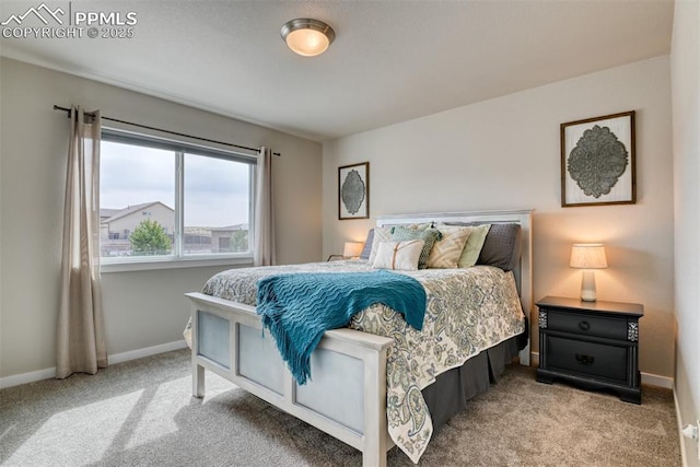 bedroom featuring light carpet and baseboards