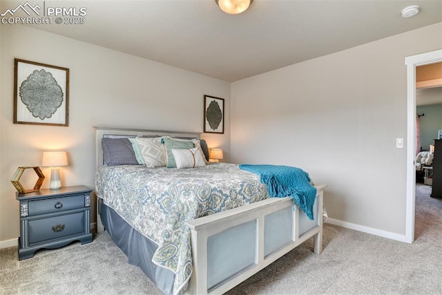 bedroom featuring baseboards and carpet