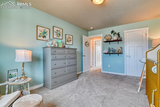 carpeted bedroom featuring baseboards and a textured ceiling