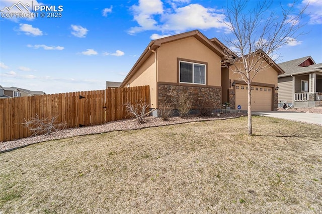 7814 Dry Willow Way, Colorado Springs, CO 80908 - view of front of home featuring concrete driveway, fence, a garage, and stucco siding
